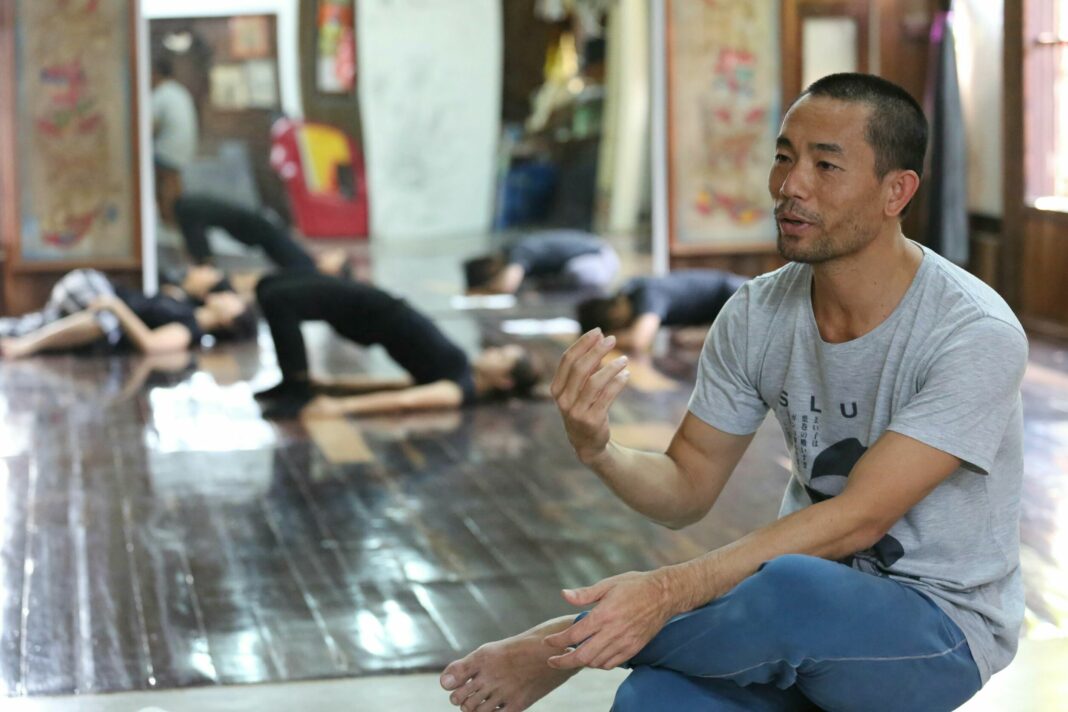 Pichet Klunchun speaks inside the home studio for his dance company in Bangkok.