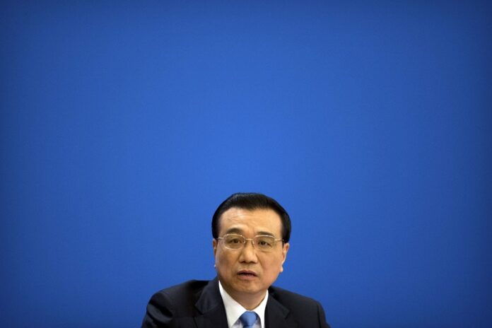 Chinese Premier Li Keqiang listens to a reporter's question during a press conference held at the conclusion of the annual meeting of China's National People's Congress (NPC) on Wednesday at the Great Hall of the People in Beijing. Photo: Mark Schiefelbein / Associated Press
