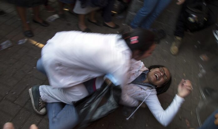 A woman who learned her child died in a fire is held by her sister on Wednesday outside the children's shelter Virgin of the Assumption Safe Home, in San Jose Pinula, Guatemala. Photo: Luis Soto / Associated Press