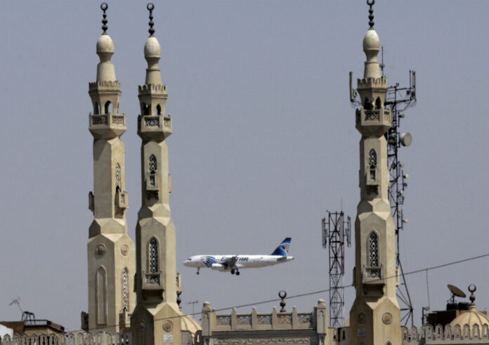 FILE - In this May 21, 2016, file photo, an EgyptAir plane flies past minarets of a mosque as it approaches Cairo International Airport, in Cairo, Egypt. Photo: Amr Nabil / AP.