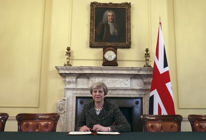 Britain's Prime Minister Theresa May sits below a painting of the country's first Prime Minister Robert Walpole in 2017 in 10 Downing Street, London. Photo: Christopher Furlong / Associated Press