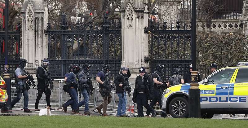 Armed police officers enter the Houses of Parliament in London, on Wednesday. Photo: Kirsty Wigglesworth / Associated Press