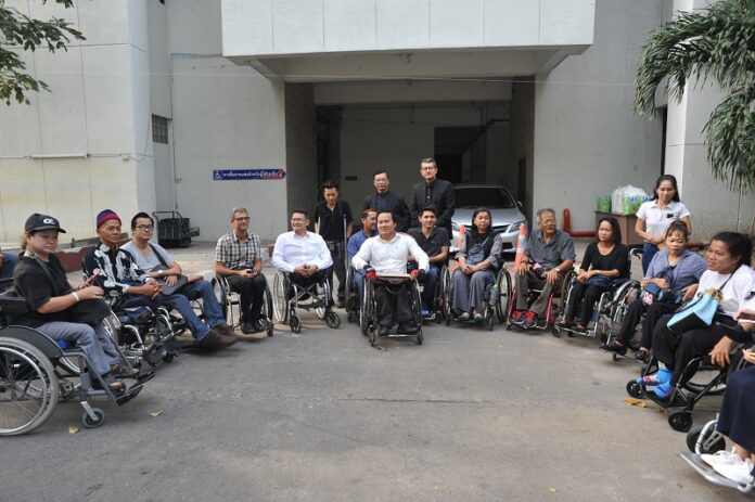 Disabled commuters gather Tuesday in front of the Civil Court in Bangkok
