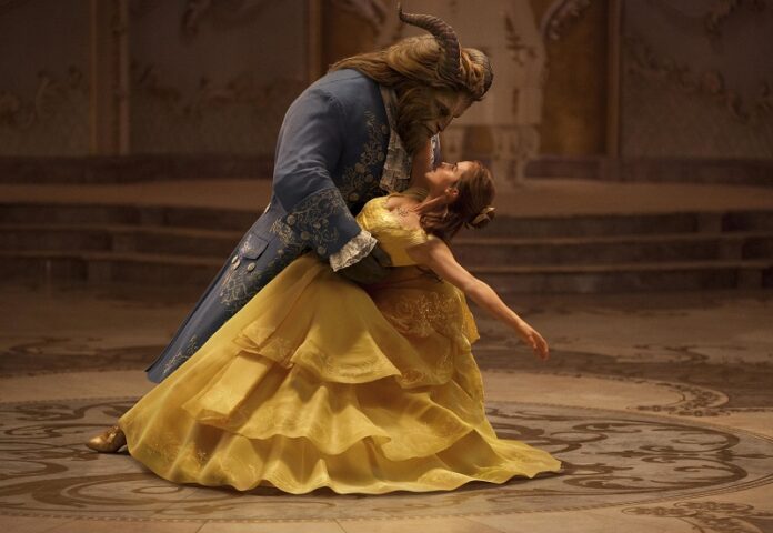 This image released by Disney shows Dan Stevens as The Beast, left, and Emma Watson as Belle in a live-action adaptation of the animated classic