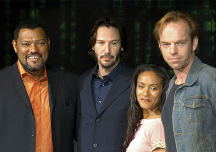 FILE - In this May 27, 2003 file photo, cast members Laurence Fishburne, from left, Keanu Reeves, Jada Pinkett Smith and Hugo Weaving pose to promote their latest film,