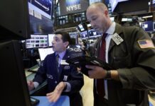 Asian Markets Slip on Fears of US Slowdown Specialist Peter Mazza, left, and trader Thomas Cicciari work in 2017 on the floor of the New York Stock Exchange. Photo: Richard Drew / Associated Press