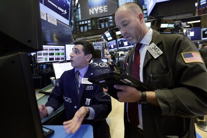 Specialist Peter Mazza, left, and trader Thomas Cicciari work in 2017 on the floor of the New York Stock Exchange. Photo: Richard Drew / Associated Press