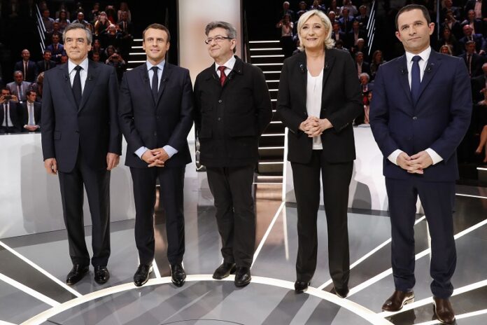 From left to right, Conservative presidential candidate Francois Fillon, Independent centrist presidential candidate for the presidential election Emmanuel Macron, Far-left presidential candidate for the presidential election Jean-Luc Melenchon, Far-right presidential candidate for the presidential election Marine Le Pen and Socialist candidate for the presidential election Benoit Hamon pose for a group photo on Monday prior to a television debate at French TV station TF1 in Aubervilliers, outside Paris, France, Monday, March 20, 2017. Photo: Patrick Kovarik / Associated Press