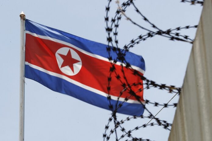 North Korean flag flutters behind razor wire on top of a wall at the North Korean Embassy, March 13 in Kuala Lumpur, Malaysia. Photo: Vincent Thian / Associated Press