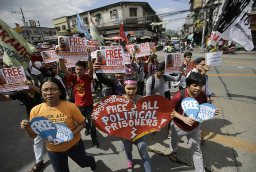 Protesters march toward Camp Crame police headquarters in suburban Quezon city, north of Manila, as they hold a rally to call on the release of Filipino activist Ferdinand Castillo and to urge Philippine President Rodrigo Duterte to resume peace talks with communist rebels on Tuesday. Photo: Aaron Favila / Associated Press