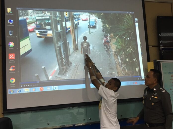Samran Muangkiew points to himself in a security camera footage that police said implicated him in the fire.
