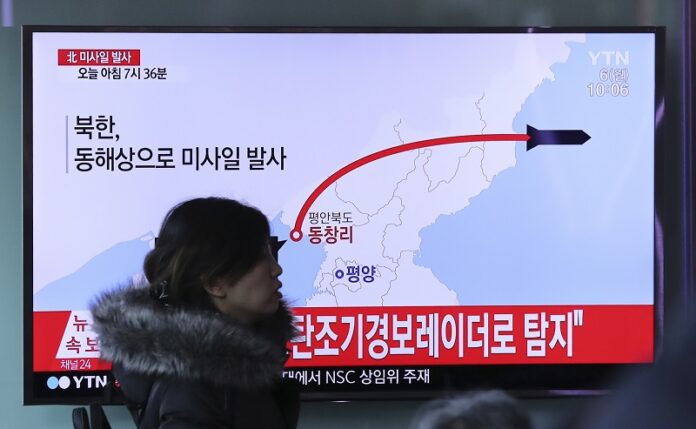 A visitor walks by the TV screen showing a news program reporting about North Korea's missile firing, Monday at Seoul Train Station in Seoul, South Korea. Photo: Lee Jin-man / Associated Press