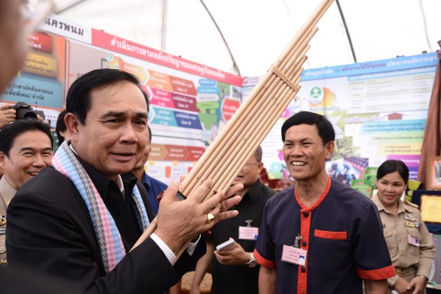 Yes Tu Khaen PM Prayuth poses with a traditional wind instrument Monday in Nakhon Phanom