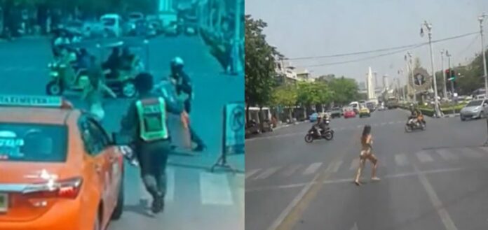 A 36-year-old Frenchwoman streaks down Ratchadamnoen Road Tuesday near the Democracy Monument in Bangkok.