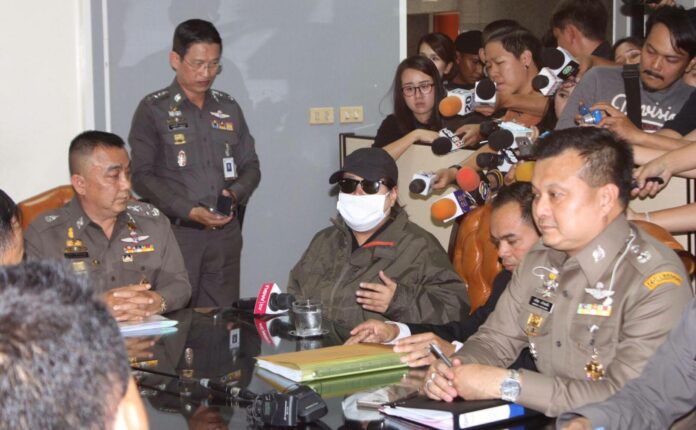 Deputy national police chief Srivara Ransibrahmanakul, seated at left, listens as a woman, wearing face mask, talks Tuesday about her daughter being victimized in an alleged child sex ring in the northern province of Mae Hong Son. Photo: Matichon