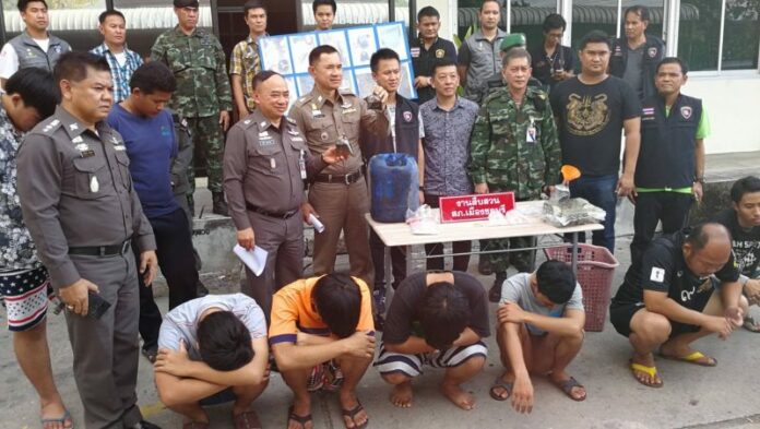 Local Chonburi police hold up bags of fish sauce used by a group of men who threw them at motorists Thursday.