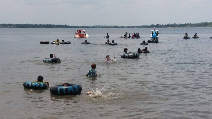 Children play in water Tuesday in Maha Sarakham province.