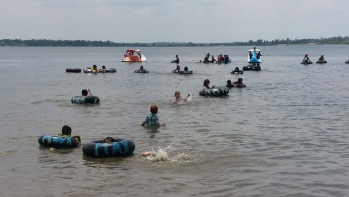 Children play in water Tuesday in Maha Sarakham province.