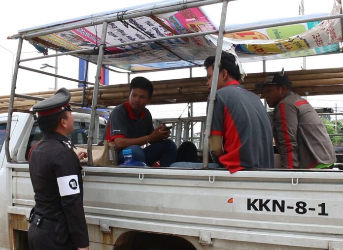A policeman in Khon Kaen stops a pickup truck on Wednesday that apparently violates the newly enforced rule of no riding on the back.