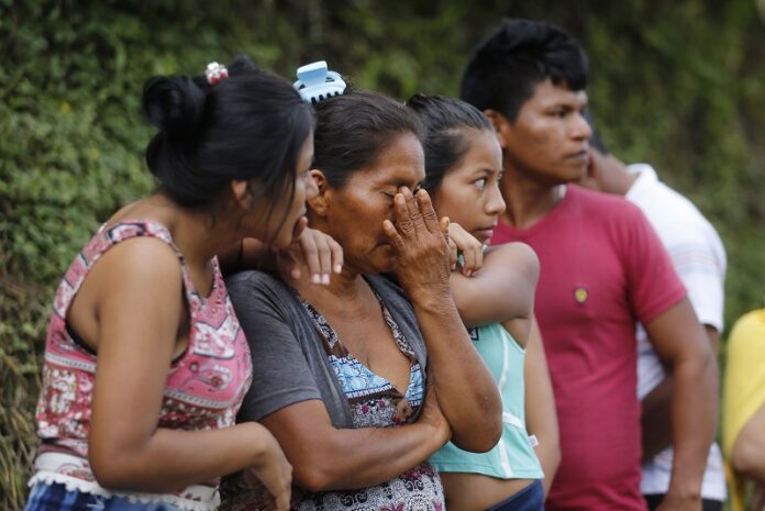 People line up outside a cemetery to looking for their missing relatives Sunday in Mocoa, Colombia. Photo: Fernando Vergara / Associated Press