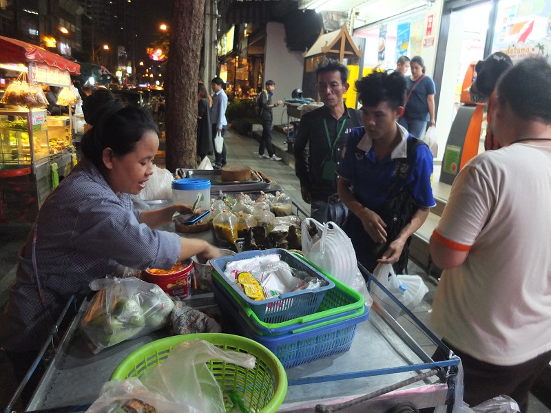 A street vendor sells goods from her stall in March in Thonglor. Photo: Sasiwan Mokkhasen