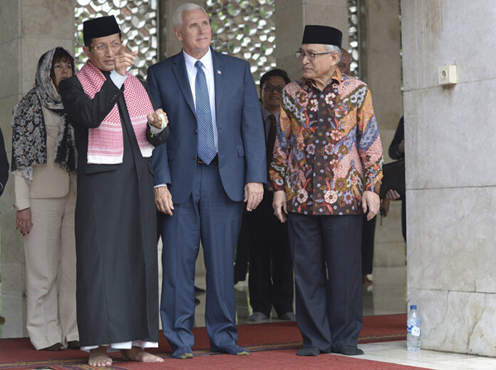U.S. Vice President Mike Pence, center, is given a tour by the Grand Imam of Istiqlal Mosque Nasaruddin Umar, left, and the Chairman of the mosque Muhammad Muzammil Basyuni, right, during his 2017 visit to the largest mosque in Southeast Asia, in Jakarta. Photo: Adek Berry / Pool / Associated Press