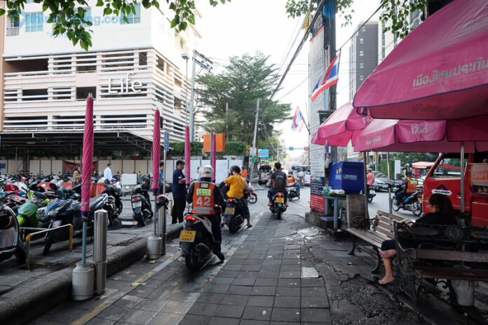 Motorbike taxis ride along a Bangkok sidewalk in a file photo. Photo: Matichon