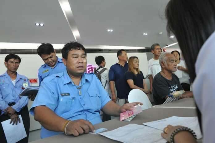 People register for a government welfare program Monday at the Government Savings Bank Headquarters in Bangkok.