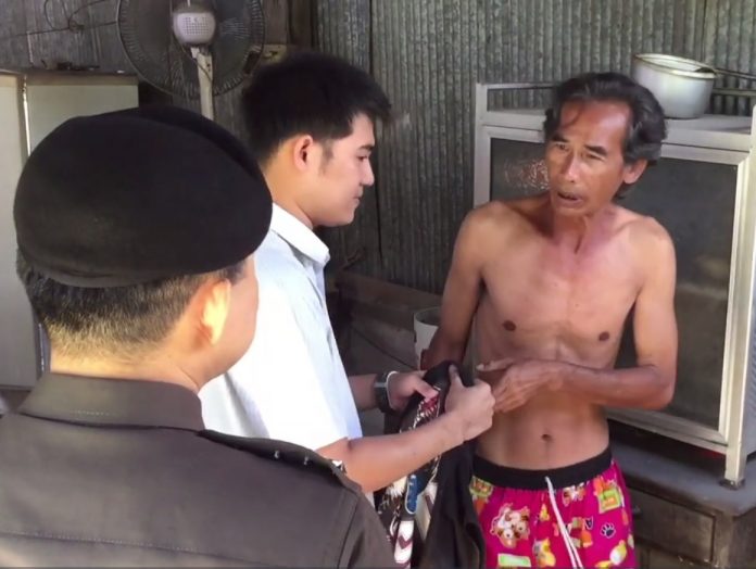 Songwit Sukprasert, at right, upon being detained by police at his home in Hua Hin on Saturday.
