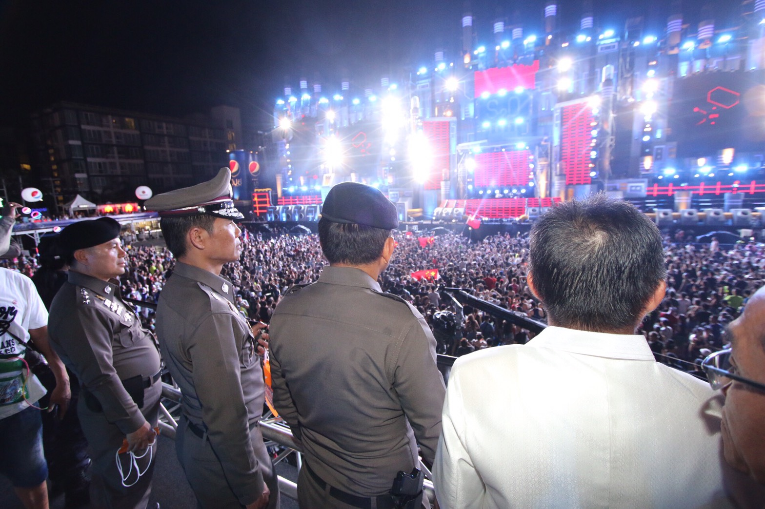 Lt. Gen. Sanit Mahathavorn watches the festivities with other policemen Thursday night at the S20 Songkran Music Festival in Bangkok.