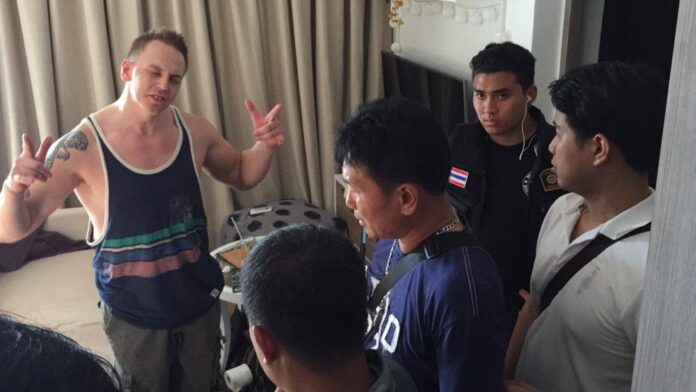 Marcus Sten Tapio Karhapaa, 34, gestures while talking to police Tuesday in Pattaya.