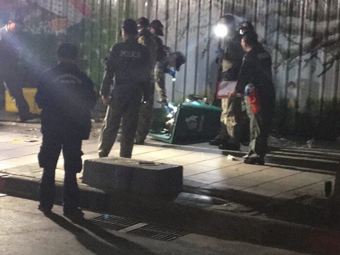 Investigators at the scene of a small bomb which exploded Wednesday on Bangkok's Ratchadamnoen Avenue.
