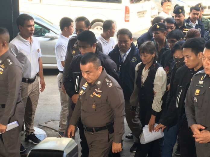 Police at the Crime Suppression Division escort eight suspects Sunday accused of involvement with a multi-level marketing scam that left more than a 1,000 travelers stranded at Suvarnabhumi Airport earlier this month.