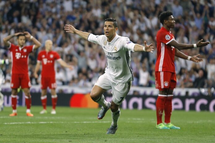 Real Madrid's Cristiano Ronaldo, center, celebrates after scoring as Bayern players react during the Champions League quarterfinal second leg soccer match between Real Madrid and Bayern Munich on Tuesday at Santiago Bernabeu stadium in Madrid, Spain. Photo: Francisco Seco / Associated Press