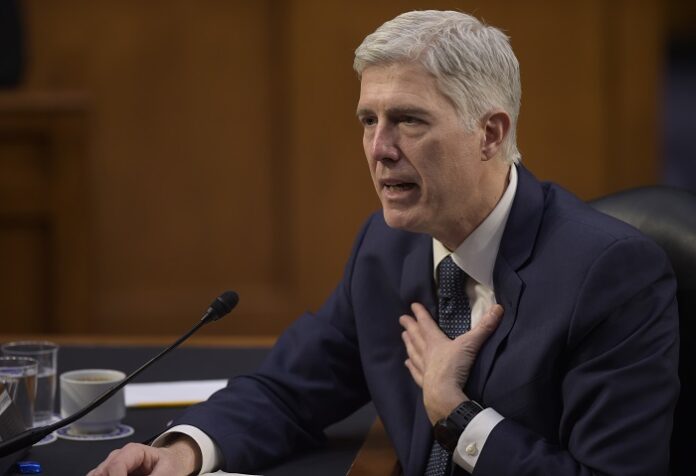 In this March 22, 2017 file photo, then-Supreme Court Justice nominee Neil Gorsuch testifies on Capitol Hill in Washington. It took less than 15 minutes for newly-minted Justice Neil Gorsuch to ask his first questions from the bench. Gorsuch and his colleagues were hearing arguments Monday for the first time since President Donald Trump's pick was sworn in April 10. (AP Photo/Susan Walsh, File)