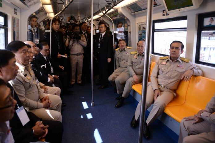 Gen. Prayuth Chan-ocha rides the BTS to the newly opened Samrong station Monday.