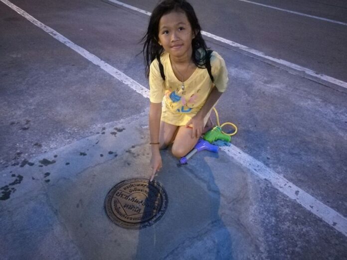 A girl points at the new plaque Friday afternoon.
