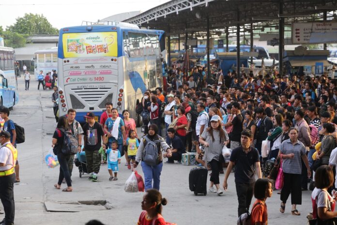 Travelers arrive last year to Bangkok's Mo Chit bus and van terminal from Songkran holidays.
