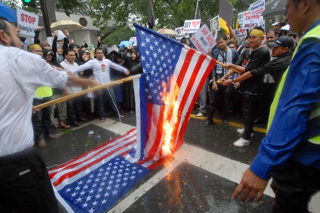Scofflaws torch an American flag in front of the U.S. Embassy in Bangkok on Sept. 22, 2012. They escaped punishment.