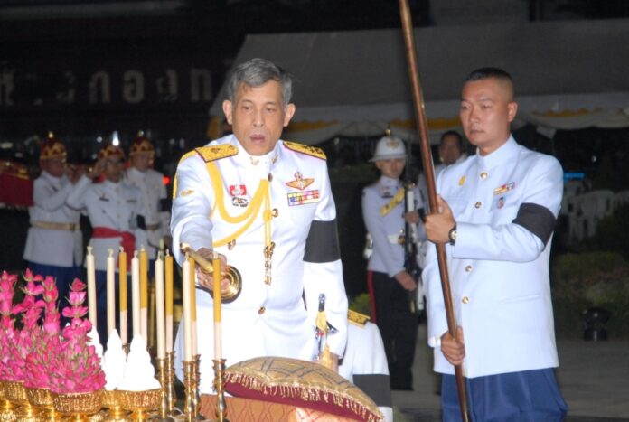 King Vajiralongkorn lights a candle at a ceremony honoring King Taksin Day on Dec. 28.