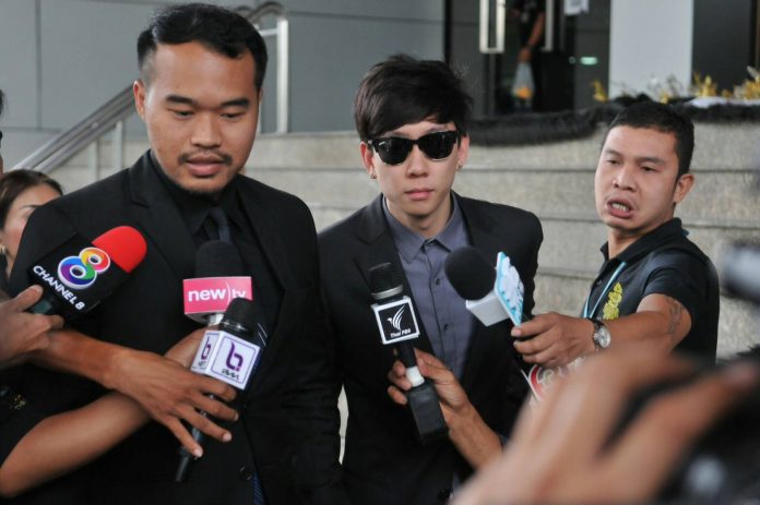 Akarakit Worarojcharoendet, wearing sunglasses, Monday outside Bangkok’s Criminal Court.