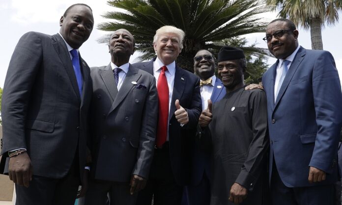 U.S. President Donald Trump gives a thumbs up as he poses with African leaders, from left, Kenya's President Uhuru Kenyatta, President of the African Union Alpha Conde', President of the African Development Bank Akinwumi Adesina, Nigeria's Vice President Yemi Osinbajo and Ethiopia's Prime Minister Haile Mariam Desalegn, Saturday in the Sicilian town of Taormina, Italy. Photo: Andrew Medichini / Associated Press