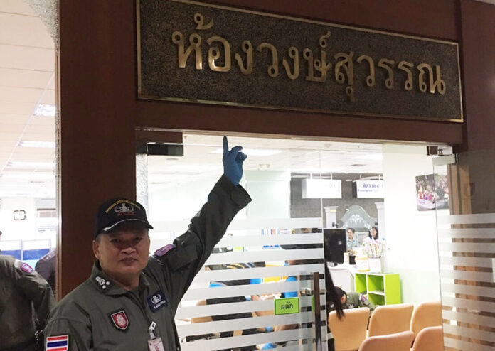 An EOD officer points to sign identifying the reception room attacked by bomb attack Monday at Phramongkutklao Hospital as Wongsuwan Room, named after the family of deputy junta chairman Prawit Wongsuwan.