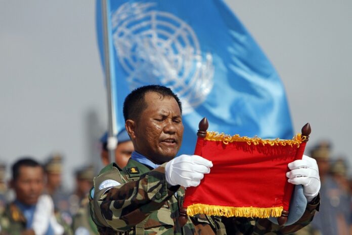 A Cambodian soldier who leads a troop takes the oath of the United Nations mission in Mali and South Sudan in Africa during a send-off ceremony for the Cambodian military personnel at the Royal Cambodian Air Force in 2015 in Phnom Penh, Cambodia. Photo: Heng Sinith / Associated Press