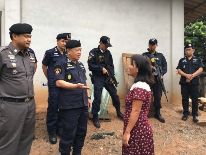 Police Lt. Gen. Poonsub Prasertsak talks to a woman during Friday morning raids of ethnic communities in Chiang Mai province.