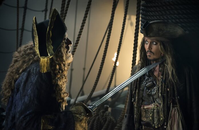 In this image released by Disney, Geoffrey Rush portrays Barbossa, left, and Johnny Depp portrays Captain Jack Sparrow in a scene from