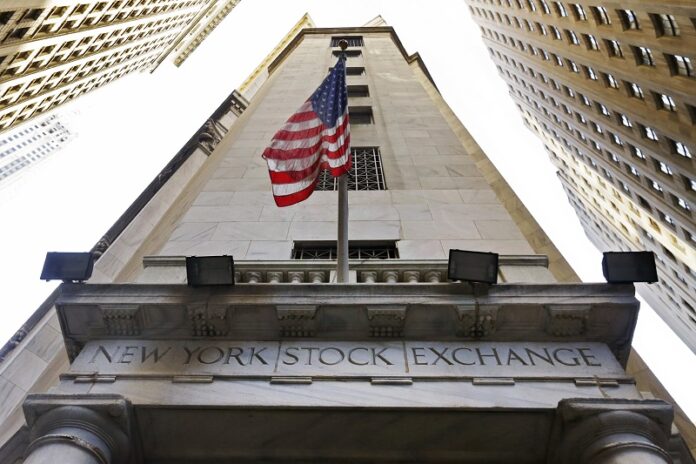 The American flag flies in 2015 above the Wall Street entrance to the New York Stock Exchange. Photo: Richard Drew / Associated Press
