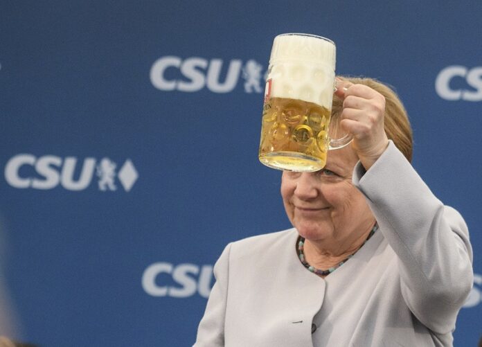 German Chancellor Angela Merkel lifts a glass of beer during an election campaign of her Christian Democratic Union, CDU, and the Christian Social Union, CSU, Sunday in Munich, southern Germany. Photo: Matthias Balk / Associated Press