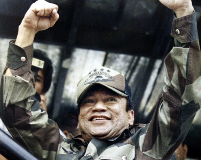 Panamanian military strongman Gen. Manuel Noriega raises his fists to acknowledge the crowd cheers during a Dignity Battalion rally in1988 in Panama City. Photo: John Hopper / Associated Press