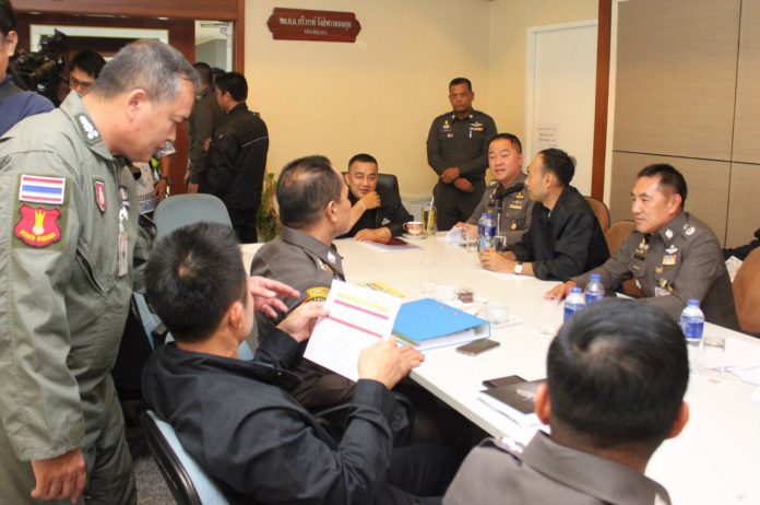 Deputy police commissioner Srivara Ransibrahmanakul, seated at center, speaks Tuesday afternoon at Royal Thai Police headquarters in Bangkok.